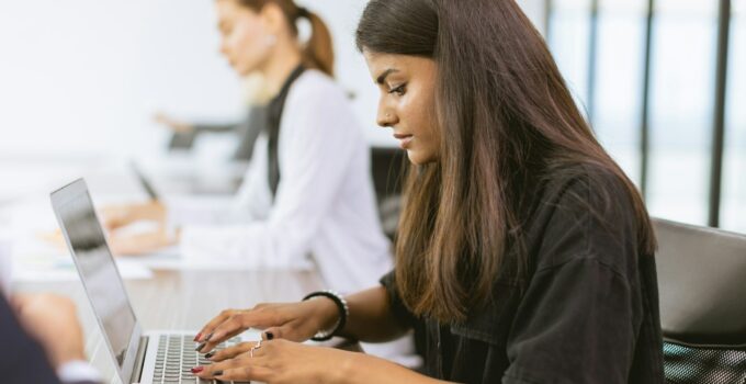 India business woman employee woking in office typing data in laptop computer