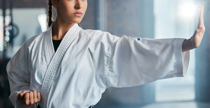 Karate, fitness and sport with woman, workout and training for fight, fitness and exercise in gym.