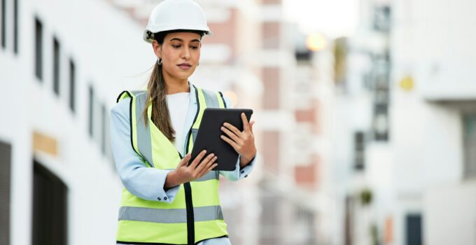 City, digital tablet and woman construction worker with software app for management, site planning
