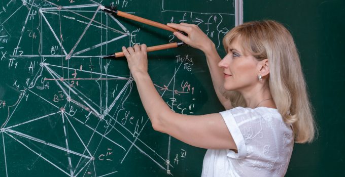 Back to school. The professor solves the problem at the blackboard