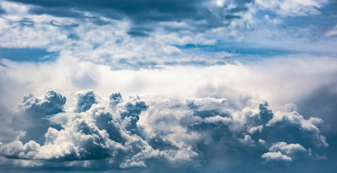 Dramatic sky, light from heaven. Cumulus stormy clouds in summer
