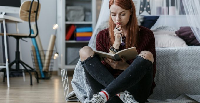 Girl thinking over notebook
