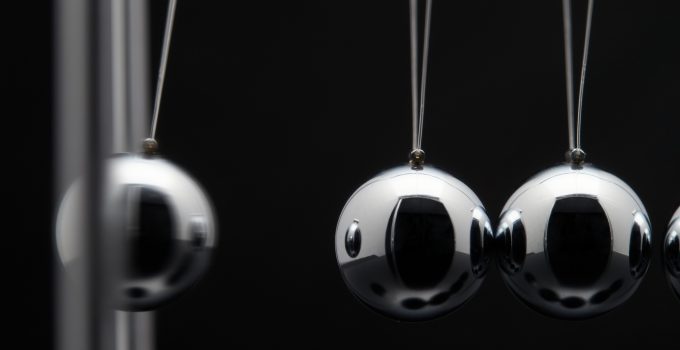 Closeup Of Newton Balls With Swinging Metal Spheres