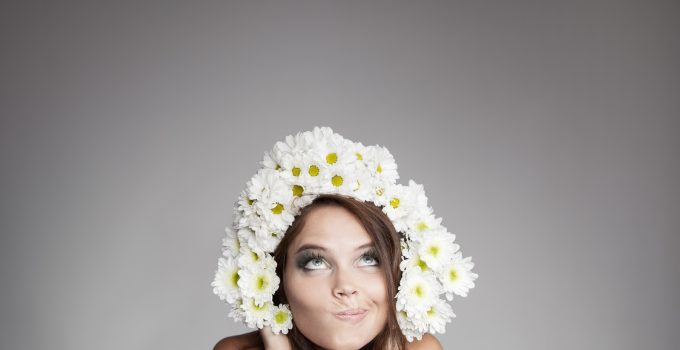 Surprised Thinking Woman With Flower Wreath Looking Up