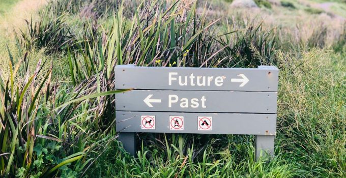 a sign in the middle of a grassy field