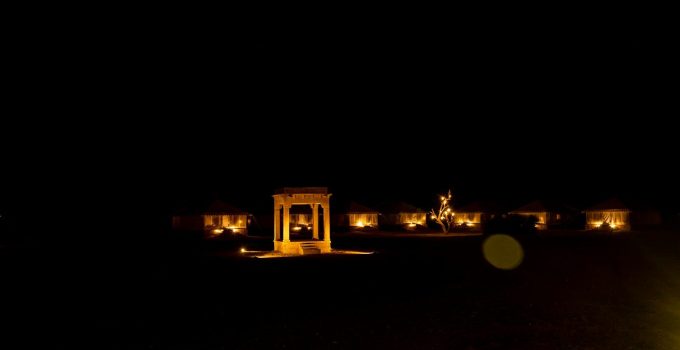 a couple of buildings lit up at night