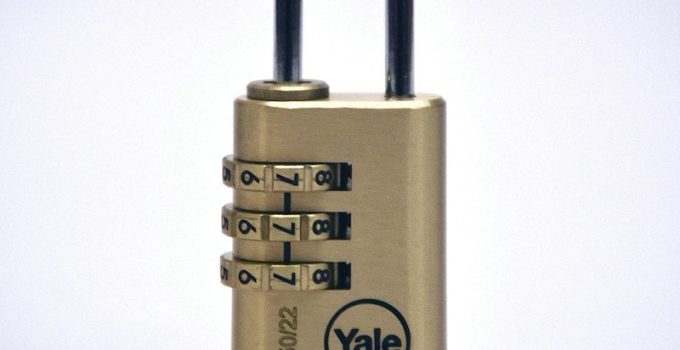 Brass Yale combination padlock against a plain gray background