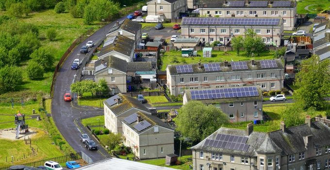 Aerial view of a residential neighborhood with solar panels on the rooftops of houses